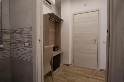a bathroom with a shower and a sliding door at Vatican City Relais in Rome