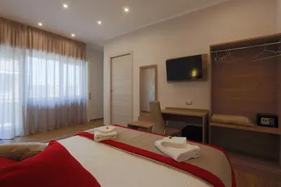 a bedroom with a large bed with towels on it at Vatican City Relais in Rome
