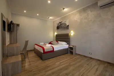 a bedroom with a bed and a television in it at Vatican City Relais in Rome