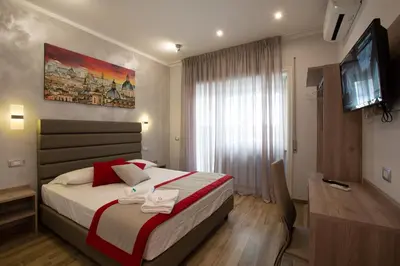 a bedroom with a bed and a flat screen tv at Vatican City Relais in Rome