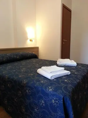 a bed with two towels sitting on top of it at Marziah Inn in Rome