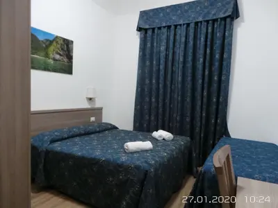a bedroom with two beds with towels on them at Marziah Inn in Rome