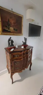 a wooden dresser in a room with a painting on the wall at Pantheon Domus Valentino in Rome