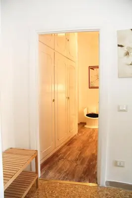 a room with a closet and a wooden floor at Maison Velia in Rome