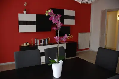 a dining room with a table and a vase with flowers at Granny's House Colosseum in Rome
