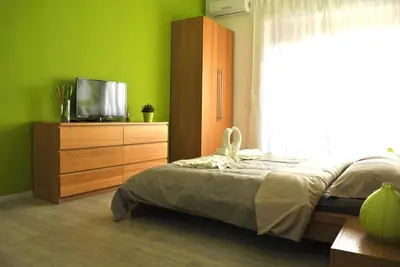 a bedroom with a bed and a dresser with a television at Granny's House Colosseum in Rome