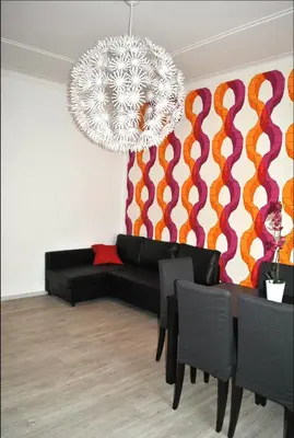 a living room with a black couch and a chandelier at Granny's House Colosseum in Rome