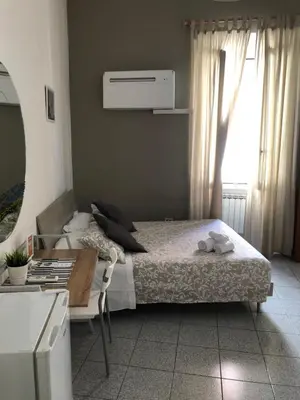 a bedroom with a bed and a window at Domus Santa Caterina in Rome
