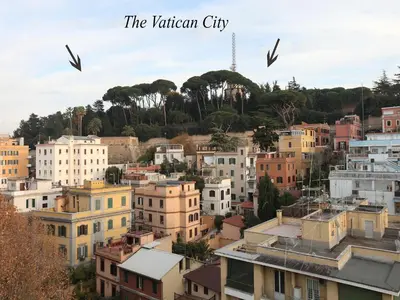 a city with buildings and birds flying in the sky at Angelo Emo Terrace in Rome