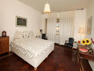 a bedroom with a bed and a table and chairs at Angelo Emo Home in Rome