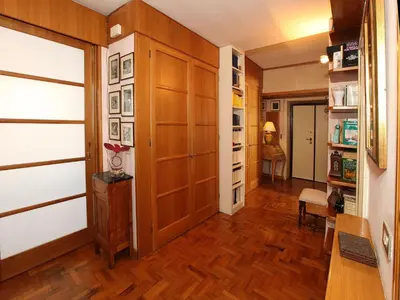 a hallway with wood paneling and a room with a closet at Angelo Emo Home in Rome