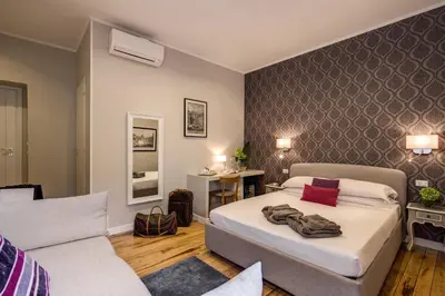a bedroom with a bed and a couch at The Club Navona in Rome