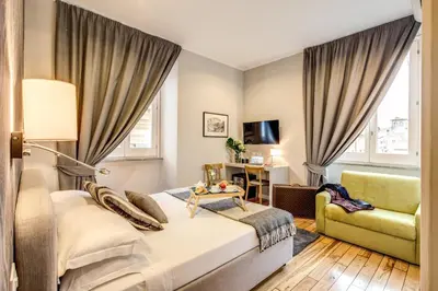 a hotel room with a bed and a chair at The Club Navona in Rome
