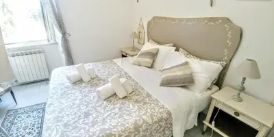 a bedroom with a large white bed with pillows at B&B Next Stop in Rome