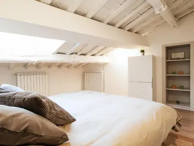 a bedroom with a large white bed in a room at Spanish Steps Luxury Penthouse in Rome