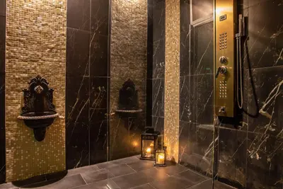 a bathroom with a sink and a candle in it at Ingrami Suites and Spa in Rome