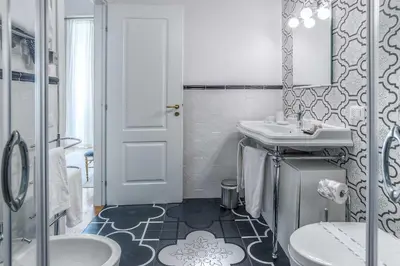 a bathroom with a sink and a toilet at Ingrami Suites and Spa in Rome