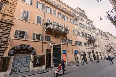 a person walking down a street with a stroller at TownHouse by the Spanish Steps in Rome
