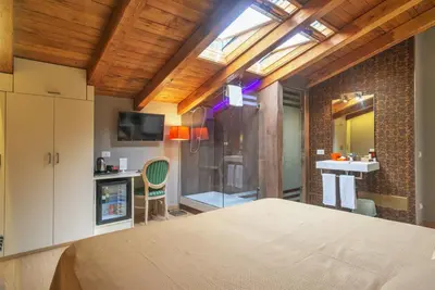 a bedroom with a large bed and a bathroom at Etruria Relais in Rome