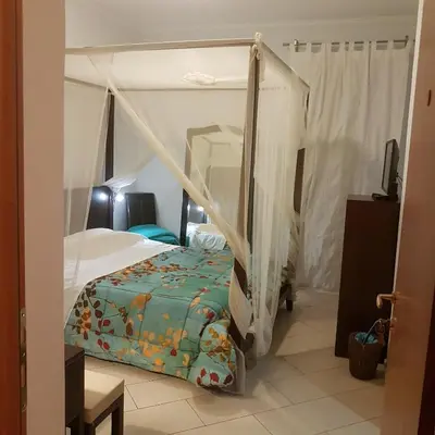a bedroom with a bed with a canopy at Dante in Rome