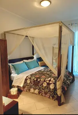 a bedroom with a bed with a canopy at Dante in Rome