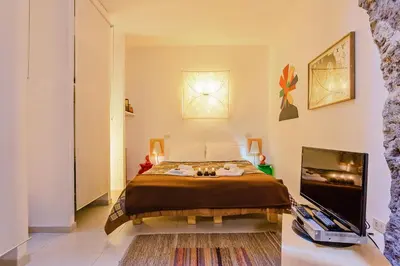 a bedroom with a bed and a flat screen tv at Rome as you feel - Selci Apartment in Rome