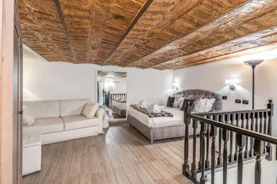 a living room with a bed and a couch at Operà Suites Pinciana in Rome