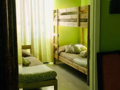 a room with two bunk beds and a mirror at Gli Alloggi Di Papà in Rome