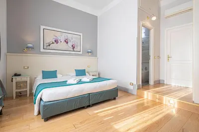 a bedroom with a large bed with blue sheets at Domus Castrense in Rome