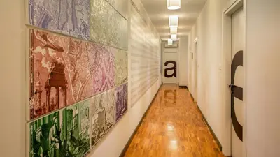 a hallway with a large painting on the wall at Suitedreams in Rome