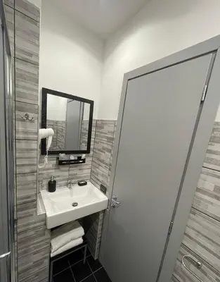 a bathroom with a sink and a mirror and a shower at Residenza Cola Di Rienzo - Suite In Rome in Rome