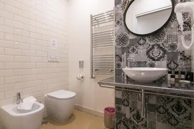 a bathroom with a toilet and a sink and a mirror at Spagna Ave in Rome