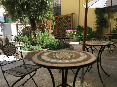 a group of tables and chairs in a patio at Domus Terenzio in Rome