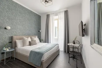a bedroom with a bed and a table and a window at Residenza Vaticana in Rome