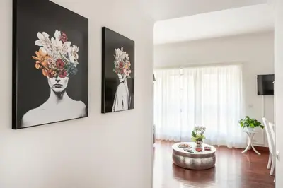 a living room with three pictures on the wall at HOME SWEET HOLIDAY srl in Rome