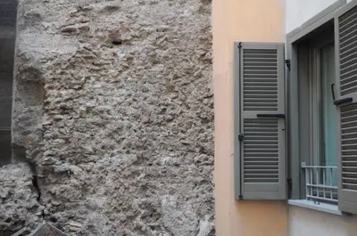 a building with a window and a stone wall at Navona Little Home in Rome