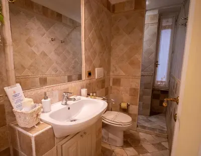 a bathroom with a sink and a toilet at Navona Little Home in Rome