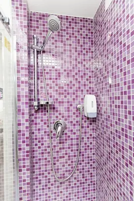a purple tiled bathroom with a shower with a shower at Re di Luna B&B in Rome