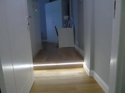 a hallway with a hallway light on a hard wood floor at Room Inn Vatican in Rome