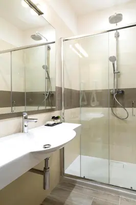 a bathroom with a glass shower and a sink at Aeterno Eco Guest House in Rome