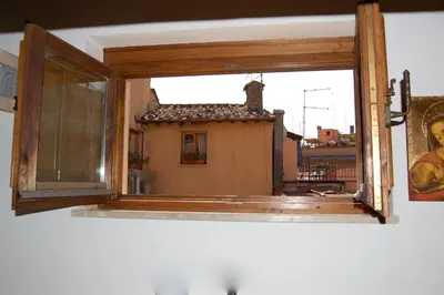a window with a view of a house at Casa Paradiso in Rome