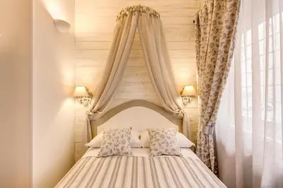 a bedroom with a canopy bed with two pillows at Casa Mia Vaticano Guest House in Rome