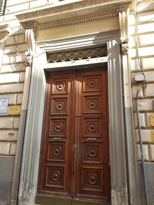 a large wooden door on a building at 3 Lati di Pitagora B&B in Rome