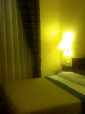 a bedroom with a bed with a lamp next to it at 3 Lati di Pitagora B&B in Rome
