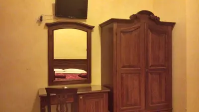a bedroom with a dresser and a mirror and a cabinet at 3 Lati di Pitagora B&B in Rome