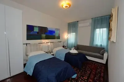 a living room with two beds and a couch at Tintoretto Inn B&B in Rome