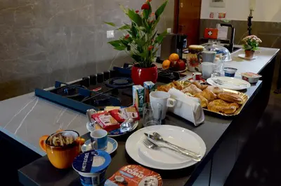 a table with food and plates of food on it at Tintoretto Inn B&B in Rome