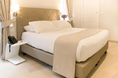 a bedroom with a bed with a phone on it at Hotel Scalinata Di Spagna in Rome