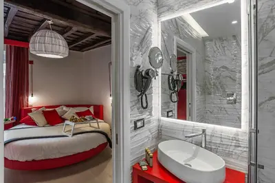 a bathroom with a bed and a tub and a sink at Spagna Luxury'n Trevi in Rome