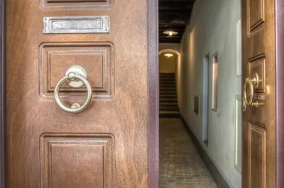 a wooden door with a handle in a hallway at Spagna Luxury'n Trevi in Rome